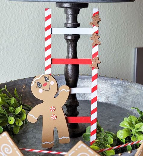 A peppermint ladder and a cute gingerbread man for your tier tray? Yes, please!! This easy ladder comes together with craft sticks and a cute gingerbread man from @24hourcraft painted to perfection completes this DIY project! Diy Mini Ladder For Tiered Tray, Gingerbread Diy Decorations, Gingerbread Crafts Diy, Gingerbread Signs, Gingerbread Diy Crafts, Christmas Ladder, Christmas Reef, Gingerbread Tree, Cute Gingerbread Man