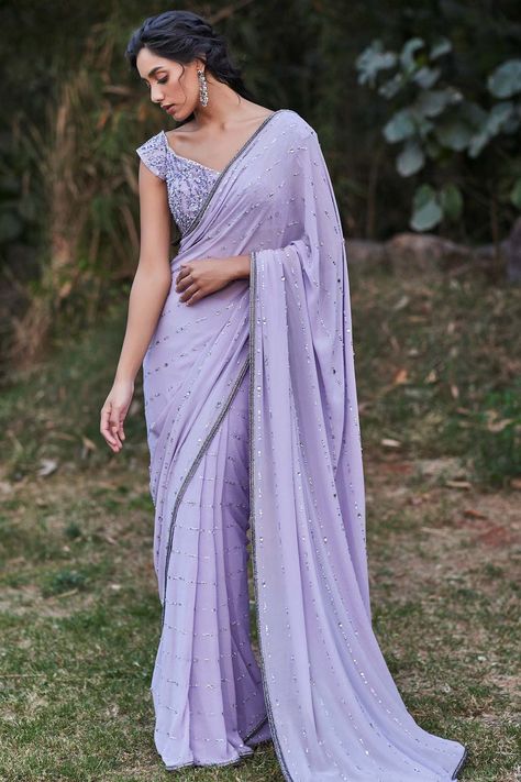 Featuring a lilac saree in crepe base with katdana, sequins, beads, crystals and, zircon hand embroidery. It is paired with a matching stitched off shoulder blouse.     FIT: True to size.  COMPOSITION: Georgette.  CARE: Dry clean only. Pooja Peshoria, Roka Outfits, Lilac Saree, Lilac Eye, Sarees For Girls, Simple Saree Designs, Velvet Dress Designs, Eid Outfit, Modern Saree