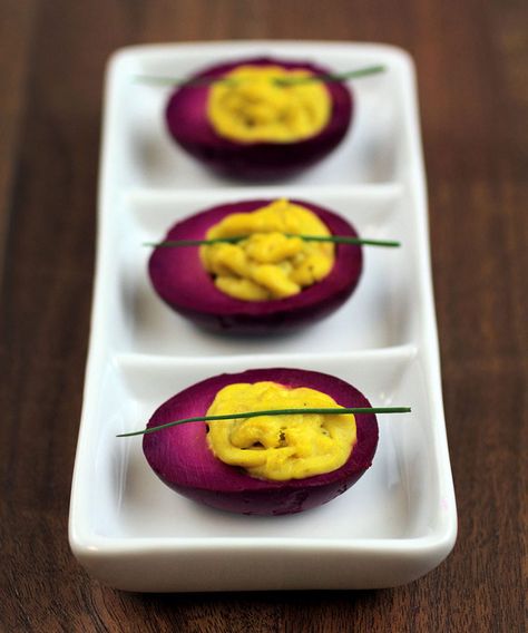 Magenta pickled curry deviled eggs on a white plate on wooden table Curried Deviled Eggs, Curry Deviled Eggs, Curry Deviled Eggs Recipe, Thanksgiving Deviled Eggs, Devilled Eggs Recipe Best, Luncheon Ideas, Eggs Ideas, Devilled Eggs, Preserving Foods