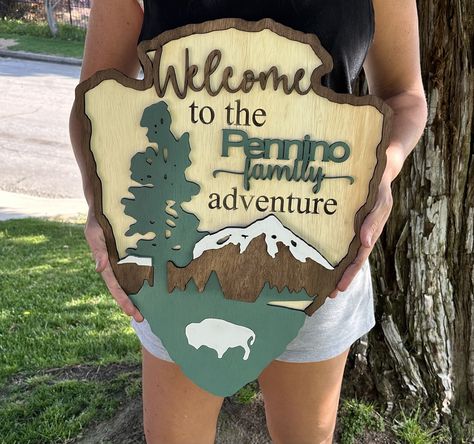 "Make your home away from home even sweeter with these beautiful National Park inspired personalized campsite signs, complete with chain and hook hangers! Signs are made from 1/4\" Baltic Birch and are roughly 23\" x 16\" and can be customized with your choice of animal: bison, bear, moose, or Bigfoot.    Leave your name for personalization in the text box along with any other special requests. We will always include \"The ---- Family\" unless otherwise specified in the textbox." National Park Signs, Hiking Gear Women, Woods Ideas, National Park Sign, Campsite Signs, School Picture Frames, Glowforge Projects, Cnc Router Projects, Diy Laser Cut