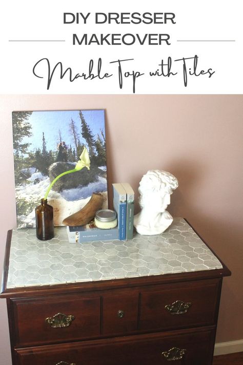 A dresser has been transformed with marble tiles for an antique look and has been styled with books, a portrait, and a vase of a flower. Tile Top Dresser, Marble Tile Diy Projects, Tile Dresser Top Diy, Marble Dresser Top, Marble Top Dresser Makeover, Tiled Dresser, Diy Marble Vanity Top, How To Paint Cultured Marble Vanity Tops, Antique Marble Top Dresser