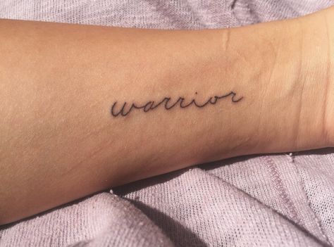 simple warrior tattoo Warrior Tattoos Simple, Tattoos For Tough Women, Simple Warrior Tattoo, Warrior Writing Tattoo, Warrior Text Tattoo, Worrier Tattoo Design, Side Foot Tattoos, Personal Tattoos, Fighter Tattoo