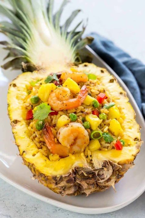 Pineapple fried rice is a quick stir-fry with Thai-inspired ingredients like jasmine rice, curry, fish sauce, red bell pepper, pineapple, peas, and shrimp. This side dish is served up in an easy to make pineapple boat for an exotic touch. #friedrice #thairecipe Pineapple Fried Rice Recipe, Rice Curry, Curry Fish, Wok Of Life, Pineapple Fried Rice, Quick Stir Fry, Pineapple Recipes, Woks, Fried Rice Recipe