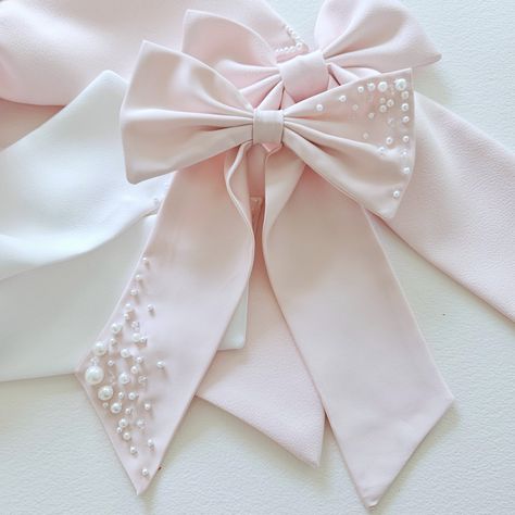 Bespoke large bow in pink satin .  Hand beaded pearl bow tails for a soft sparkle and a touch of elegance. Size: 9 inches. Materials: Satin , pearl beads Finish: Alligator clip. Hair Bow Design, Pink Wedding Hair Accessories With Decorative Bow, Elegant Pink Bow With Ribbon, Bow With Pearls, Pearl Hair Bow, Elegant Pink Ribbon Hair Accessories, Spring Pink Satin Bow Hair Accessories, Beaded Bow, Diy Hair Accessories Ribbon