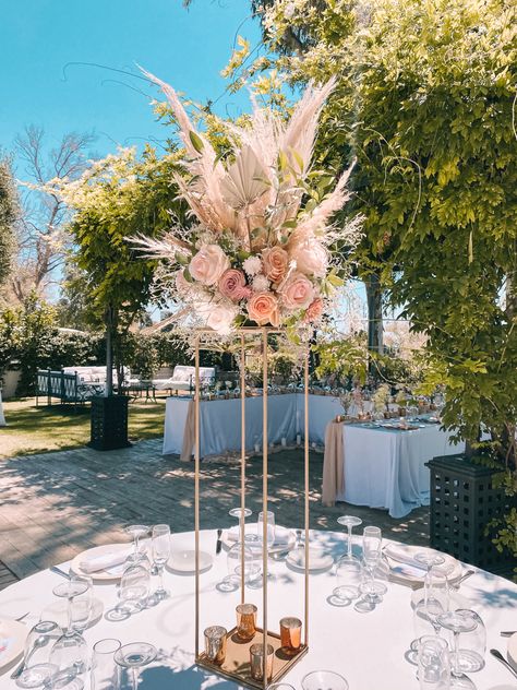 Tall centerpieces in gold stand with pampas grass Pampas And Flowers Wedding, Tall Boho Centerpieces, Pompass Grass Table Decor, Pompass Grass Centerpiece, Centerpieces With Pampas, Pampas Centerpieces Wedding, Pampas Centerpiece, Pampas Grass Centerpiece, Centerpieces Quinceanera