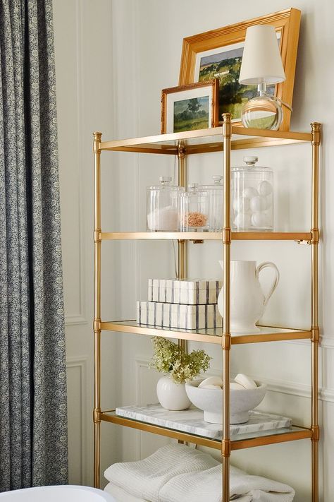 Toilet Across From Vanity, Bathroom Standing Shelf Decor, Elegant Bathroom Shelves, Bathroom Etagere Styling, Bathroom Storage Shelves Over Toilet, Gold Bathroom Storage, Traditional Home Bathroom, Chic Bathroom Storage, Gold Bathroom Shelf