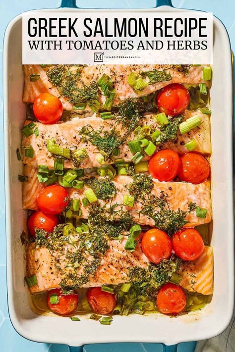 This easy Greek salmon recipe bakes salmon, green onions, and cherry tomatoes in a Greek-style sauce with dill, oregano, lemon and garlic. Salmon Baked Recipes, Greek Salmon Recipes, Mediterranean Diet Recipes Dinners Salmon, Mediterranean Salmon Recipes, Mediterranean Diet Salmon Recipes, Cod With Cherry Tomatoes, Easy Greek Recipes, Mediterranean Diet Salmon Dinner, Salmon Greek