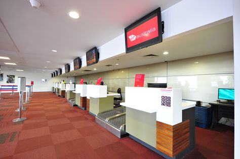 Airport check in counters with corian benchtops, wall panelling and feature timber. Airport Counter, Airport Ticket, Corian Top, Airport Tickets, Airport Check In, Bathroom Partitions, Wall Panelling, Counter Design, Exhibition Stand