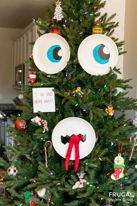 Use paper plates and make a DIY Christmas Tree Face when you create this fun Christmas Tree Monster Eating Elf on the Shelf idea. New Elf on the Shelf ideas daily plus free Elf on the Shelf printables. #FrugalCouponLiving #ElfontheShelf How To Make Your Elf On The Shelf Pregnant, Elf On The Shelf Tree House Diy, Christmas Tree Elf Ideas, Elf On The Shelf Ideas With Muffins, Elf On Shelf Thanksgiving Ideas, Elf On The Shelf Ideas With Christmas Tree, Easy Elf On The Shelf Ideas Marshmallows, Elf On The Shelf In Tree Ideas, Dollar Store Elf On The Shelf Ideas