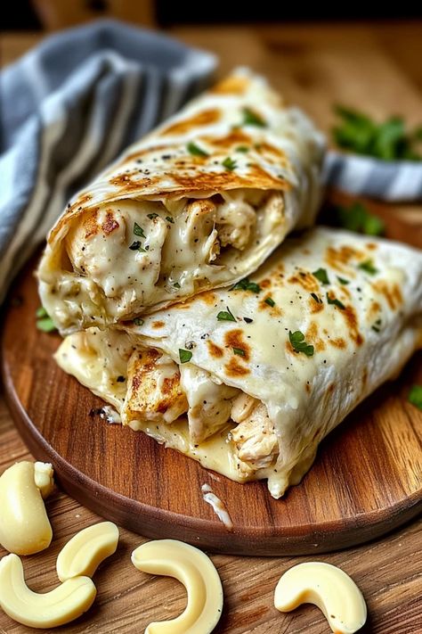 Craving a quick, cheesy delight? These Cheesy Garlic Chicken Wraps are the perfect combination of savory chicken, melted cheese, and garlic goodness. Easy to make and packed with flavor, they’re sure to become a household favorite. Surprise your taste buds – full recipe inside! #CheesyChickenWrap #GarlicChickenWrap #ChickenRecipes #EasyDinner #WrapRecipes #CheesyWraps #GarlicLovers #QuickMeals #EasyWraps #FamilyFavorite #DinnerIdeas #ChickenWraps #CheeseRecipes Garlic Chicken Wraps, Cheesy Garlic Chicken Wraps Recipe, Chicken Ceaser Wraps Recipe, Pimento Sandwiches, Cheesy Garlic Chicken Wraps, Chicken Cheese Steak, Cheesy Garlic Chicken, Grilled Chicken Wraps, Feta Cheese Recipes