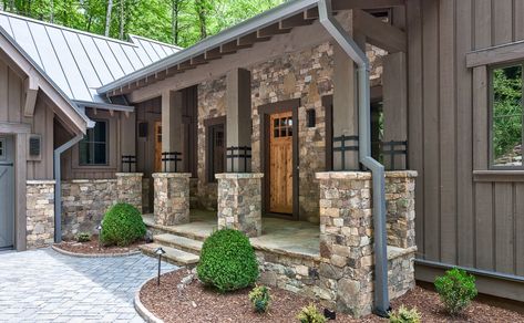 Create a grand entrance with stone accents. This home in Fraser features vertical wood siding paired with gorgeous natural stone. Vertical Siding Exterior, Cabin Siding, Vertical Wood Siding, Traditional Porch, Lake Houses Exterior, Vertical Siding, Home Exterior Ideas, James Hardie, Cabin Exterior