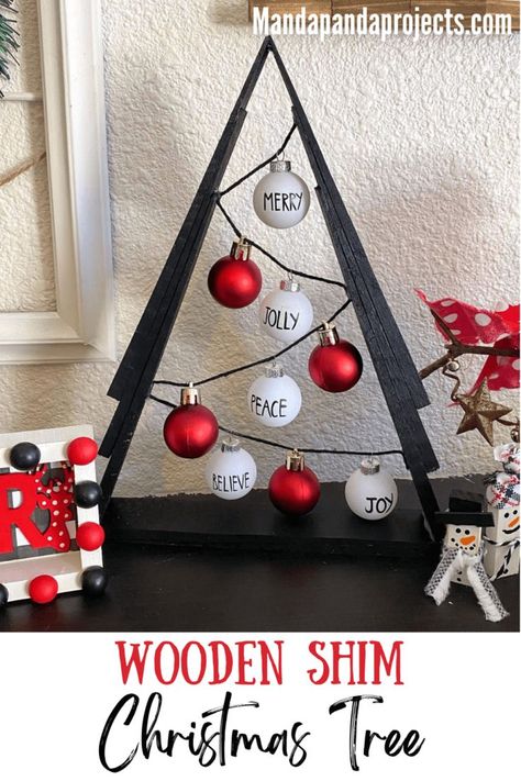 You’ll be Rockin’ around the Wooden Shim Christmas Tree this year after making this gorgeous black, red, and white themed DIY Christmas decor. This A-frame tree uses miniature Rae Dunn inspired ornaments for a sleek and classic look that’s a must add to your ‘Christmas crafts to make’ list this year! #diychristmasdecor Diy Wood Shim Christmas Trees, Wood Shim Christmas Trees, Shim Tree Ideas, Christmas Trees Made From Shims, Christmas Tree Made Out Of Shims, Wood Shim Trees, Shims Projects Ideas, Shim Christmas Trees, Shim Trees Diy