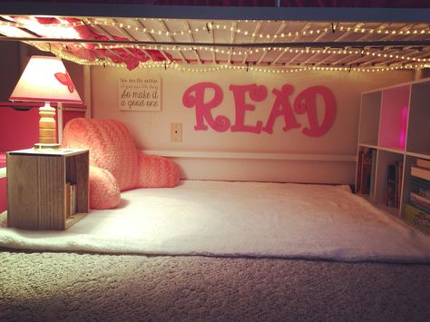 Created a cute little "Reading Nook" under my daughter's loft bed, complete with a curtain to close. Reading Space Under Loft Bed, Loft Bed Reading Nook Ideas, Reading Nook Loft Bed, Loft Bed With Reading Nook Underneath, Kids Couch Under Loft Bed, Loft Bed Nook Ideas, Under Loft Bed Reading Nook For Kids, Under Bunk Bed Reading Nook, Reading Corner Under Loft Bed