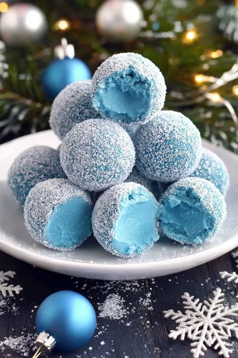 Blue Christmas Truffles start with a smooth white chocolate ganache, beautifully tinted by blue curacao, which adds a touch of warmth as they melt in your mouth. These truffles deliver a luscious blend of creamy white chocolate with a subtle citrusy note. Step into the world of holiday indulgence with these Blue Christmas Truffles—a dreamy Blue Christmas Truffles, Blue Pastries, Winter Wonderland Treats, Christmas Themed Desserts, Irish Cream Truffles, 21 Dinner, Blue Curacao Liqueur, Christmas Truffles, White Desserts