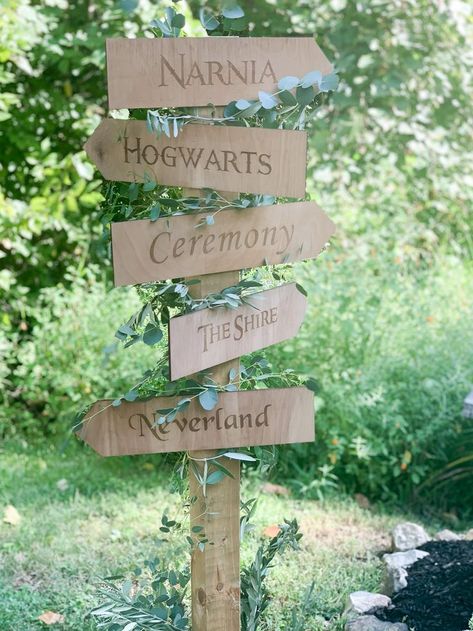 Wood Directional Post Sign with Narnia, Hogwarts, The Shire, and Neverland arrows for private estate fairytale wedding in Indianapolis decorated with greenery, , indiana calligrapher, engraved wedding invitation, carmel wedding invitations, noblesville bridal shop, brownsburg print shop, indianapolis wedding planner, lavender wedding invitation, fine art wedding, fine art wedding, artist wedding, wood wedding details, wood wedding sign, summer estate wedding, Fairytale Farm Wedding, Fairytale Wedding Aisle, Fairytale Woodland Wedding, Diy Fairytale Wedding Decor, The Shire Wedding, Narnia Themed Wedding, Narnia Wedding Theme, Wedding Decorations Fairytale, Fantasy Party Decorations