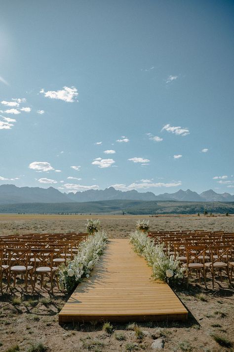 This couple had a luxury wedding with a custom wooden plank wedding aisle and a flower explosion lining the ceremony aisle #weddingaisle #weddingceremonydetails #weddingceremonydesign #weddingaltar #aisle #ceremonyflowers #ceremonyflorals #weddingceremonyaisle #luxurywedding #mountainwedding #mountainweddings #weddingdesign #weddinginspiration #weddingdecor #summerwedding #outdoorwedding #luxuryweddingdesign #weddinginspo #weddingphotography #weddingvenue #mountains Wood Aisle Runner, Woods Wedding Ceremony, Outdoor Wedding Ceremony Aisle, Idaho Wedding Venues, Aisle Ideas, Mountain Ranch Wedding, Flower Explosion, Wedding Isles, Ceremony Aisle