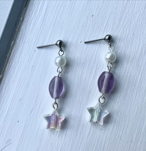 These earrings are super cute and whimsical, and are a perfect gift for the girlies that are obsessed with space and stars! The purple contrasts the white beads, and they are also hypoallergenic and safe for sensitive ears! Available now in both stud and hook forms! #earrings #handmadeearrings #handmadejewellery #jewellery #brisbanesmallbusiness #smallbusiness #fashion #smallbiz #hypoallergenic #stars #stargirl Diy Stud Earrings, Debut Planning, Space And Stars, Star Diy, Star Girl, White Beads, Sensitive Ears, The Purple, Diy Earrings