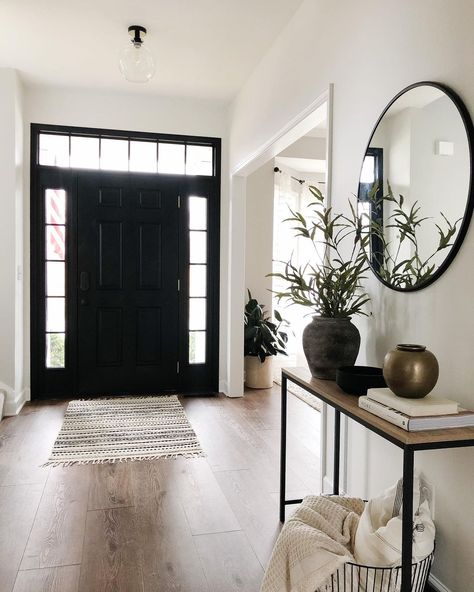 Black Entry Way Door Inside, Front Entry Door Black, Black And White Home With Wood Accents, Black White And Wood Hallway, Black Interior Front Door With Transom, Entryway Black Mirror, Black Front Door With Transom, Foyer Black Door, Black Accent Entryway