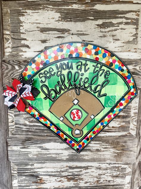 Ball Families need this Baseball Door Hanger. It is laser-cut out of 1/4 inch pretreated wood, painted with acrylic paint, and finished with a protective clear coating that prevents chipping, peeling, or fading.  It hangs from sturdy metal wire, and it is accessorized with a multi-layered deco mesh, burlap, and ribbon bow. can also be done for softball or half softball, half baseball. Baseball Doorhangers, Baseball Door Hangers, Baseball Door Hangers For Hospital, Baseball Softball Door Hanger, Baseball Front Door Sign, Baseball Fundraiser, Baseball Crafts Wreaths & Garlands, Baseball Signs, Baseball Decor