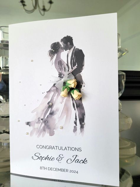 A bride and groom personalised names wedding day card in a simple black watercolour silhouette design with a paper flower bouquet and finished with white pearls on quality A5 card Watercolor Wedding Cards, Watercolour Silhouette, Handmade Wedding Cards, Wedding Card Congratulations, Silhouette Wedding, Groom Card, Wedding Day Cards, Wedding Congratulations Card, Card Flowers