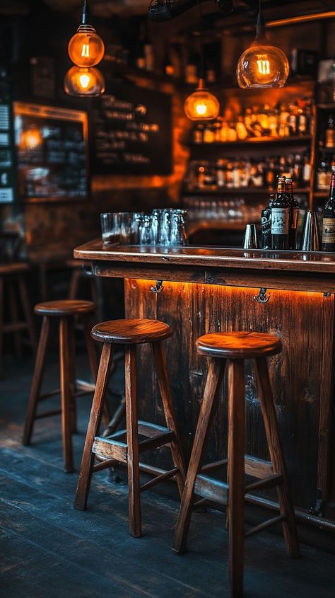 "Cozy #barinterior: A warmly lit bar features wooden stools, a #rusticdesign counter, and hanging pendant lights above. #barscene #wooddecor #designideas #homedecor #decorinspiration #aiart #aiphoto #stockcake ⬇️ Download and 📝 Prompt 👉 https://stockcake.com/i/cozy-bar-interior_1341710_578384" Bar Foods Pub, Pub Aesthetic, Scandinavian Bar, Brand Deck, Terceira Azores, Future Restaurant, Ski Bar, Cabin Bar, Bar Aesthetic