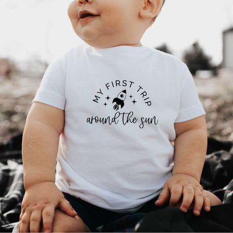 Celebrate your toddler's first trip around the sun with this adorable rocket-themed t-shirt! 🚀 Perfect for little explorers and space enthusiasts. Available in various sizes. #toddlerfashion #rocketshirt #firstbirthday #spaceexplorer #toddlerstyle  Please note that the Pin URL is an affiliate link. Bday Themes, Toddler Ootd, Sun Birthday, First Trip Around The Sun, Sun Design, Toddler Tops, Boy Decor, Cadeau Photo, Birthday Themes