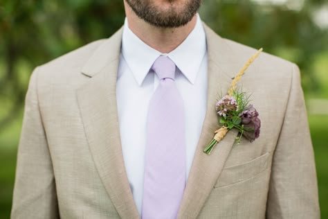 Tan jacket with a lavender and wild grass boutonniere for an August wedding in Sheridan, WY Tan Suit With Purple Tie, Tan And Lavender Suit, Lavender And Tan Wedding, Lavender Wedding Groomsmen, Lilac And Tan Wedding, Mens Grey Suit Wedding Lavender, Tan Suit Purple Tie, Grey And Lavender Groomsmen, Groomsmen Attire Lavender Gray