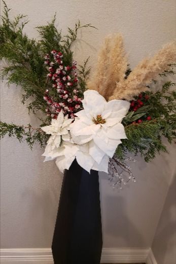 My homes accent color is black and these white poinsettias blend in very easily. I added a few stems of pampas to help compliment the backsplash and countertops in the kitchen. Poinsettia Bouquet, Christmas Bush, White Poinsettia, Christmas Floral Arrangements, Cemetery Flowers, Christmas Floral, Floral Arrangement, Poinsettia, Accent Colors