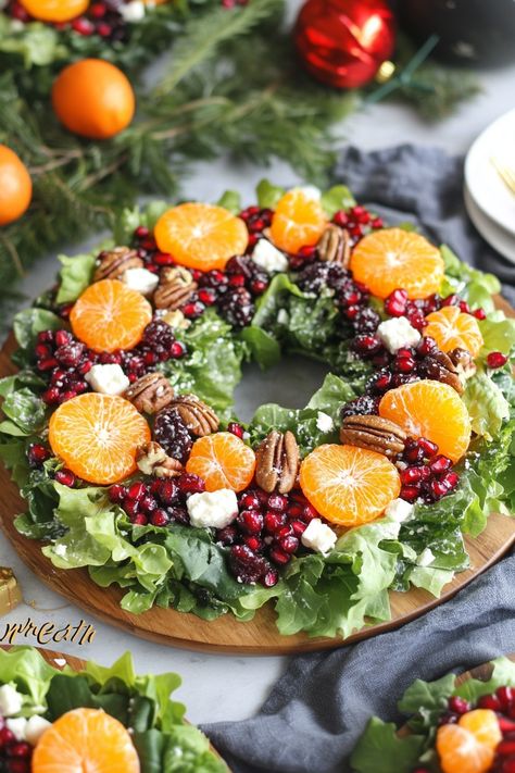 Create a stunning Winter Salad Wreath for your holiday table! Vibrant greens, citrus, pomegranate, and feta come together in this festive dish. A perfect mix of flavors and textures for Christmas celebrations. Pin now and make this show-stopping salad for your holiday menu! Xmas Fruit Salad Christmas, Christmas Eve Salad Recipes, Christmas Salad Wreath Ideas, Christmas Salad With Mandarin Oranges, Arugula Christmas Wreath Salad, Pioneer Woman Christmas Wreath Salad, Salad For Buffet, Citrus Christmas Centerpiece, Christmas Summer Salad