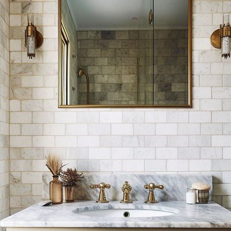 STAREL stones on Instagram: "When it comes to creating classic British bathroom there is nothing more authentic and traditional than a marble counter and a good old metro tile on the wall. 75x150mm Calactta marble metro tiles being the most famous of them all. Stunning 1:2 ratio and a small format of these tiles allows you to lay them in the desired pattern, whether that’s a subway, herringbone or vertical stack. Learn more on our website and order your samples today." Marble Brick Tiles Bathroom, Marble Metro Tiles Bathroom, Brick Tiles Bathroom, Metro Tiles Bathroom, Herringbone Tile Bathroom, British Bathroom, Bathroom 2024, Brick Laying, Marble Subway Tiles