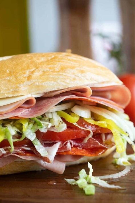 Filled with cheese and lots of Italian meats, skip the sandwich shop and make this Italian Sub recipe at home! This is the perfect sandwich for and easy dinner at home. Mini Italian Subs, Hoagie Sandwich Ideas, Dressing For Italian Subs, Italian Combo Sandwich Recipe, Baked Italian Sub Sandwich, Italian Subs Sandwich, Sub Sandwiches Ideas, Cold Sub Sandwich Ideas, Italian Hoagie Sandwiches