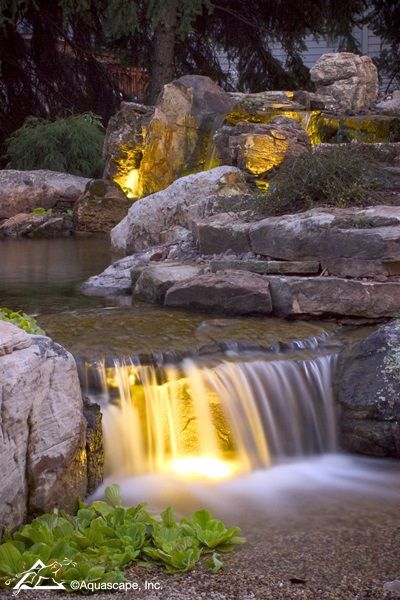 Backyard Waterfall with Lighting at Night #backyardideas #pond #waterfall #lighting #landscapedesign #koi Koi Pond Lighting, Waterfall Lighting, Pond With Stream And Waterfall, Waterfall Into A Pond, Organic Pool, Pond Lights Underwater, Pond Lighting, Ranch Landscaping, Pretty Backyard