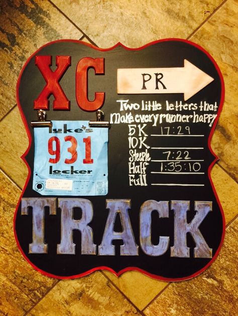 XC Cross Country, Track & Marathon run. Created a PR board for my son. Neat way to use bibs & track PR. I used a decor wood board I bought @ local hobby store that had a painting on it (cheaper then wood) I painted with black chalkboard paint and then painted edges with red chalk paint and dark wax finish. Letters I bought unfinished & made my own chalk paint. Painted, distressed by sanding, dark wax and then clear wax.  Other lettering free hand with sharper.  Now we just update with chalk. Track Locker Decorations, Track Banquet Centerpieces, Cross Country Decorations, Cross Country Gift, Red Chalk Paint, Xc Running, Running Guide, Black Chalkboard Paint, Track Quotes