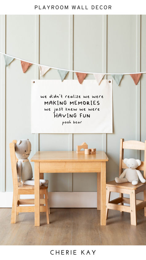 Hanging canvas wall decor featuring the quote "We didn't realize we were making memories, we just knew we were having fun" by Pooh Bear, styled in a cozy playroom with wooden furniture, neutral tones, and a playful pennant banner for a charming and inviting kids' space. Diy Playroom Wall Decor, Gift Ideas For New Parents, Canvas Flag, Diy Playroom, Playroom Signs, Bear Quote, Room Wall Decor Ideas, Playroom Wall Decor, Quote Canvas