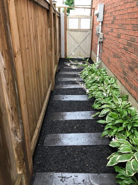 Black Mulch Walkway, Black Mulch With Pavers, Pavers On Mulch, Mulch Walkway Stepping Stones, Black Mulch Garden Ideas, Side Yard Stepping Stones, Dark Mulch Landscaping, Mulch Pathway Ideas, Black Stepping Stones