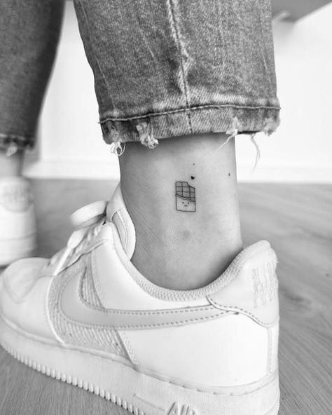 Below Ankle Tattoo, Fine Line Daughter Tattoo, Tattoo Ideas On The Leg, Tattoo Ankle Woman, Chocolate Bar Tattoo, Chocolate Tattoos, Outside Ankle Tattoo, M&m Tattoo, Single Needle Tattoo Ideas Women