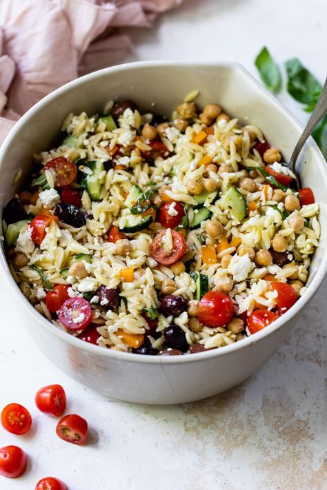 This Greek-inspired orzo pasta salad recipe is loaded with Mediterranean flavor thanks to the feta, olives, chickpeas, and basil. Delish! Greek Orzo Pasta Salad Recipe, Greek Orzo Pasta Salad, Greek Orzo Pasta, Orzo Pasta Salad Recipe, Rice Salads, Greek Orzo, Feta Pasta Salad, Potato Salad Healthy, Orzo Pasta Salad