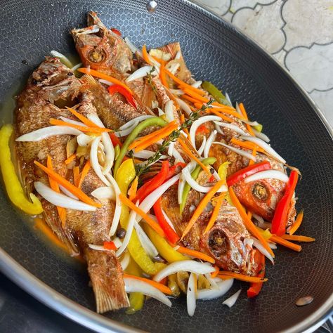 What are you pairing this escovitch fish with? Cookware @hexclad Escovitch Sauce Recipe Ingredients: - 1 cup Vinegar - 1 cup Water - 1 tablespoon White Granulated Sugar - Salt and Pepper to taste - 1-2 Carrots, julienned - 3-4 Small Onions, julienned - 6-9 Scotch Bonnet Peppers, sliced - 30 Allspice Berries (about 10 per jar) - 1 head of Garlic, 2-3 pieces per jar Instructions: 1. In a saucepan, combine the vinegar, water, white granulated sugar, salt, and pepper. Simmer the mixture over... Escovitch Sauce Recipe, Escovitch Fish, Scotch Bonnet Pepper, Scotch Bonnet, Garlic Head, Recipe Ingredients, Sauce Recipe, Granulated Sugar, Sauce Recipes