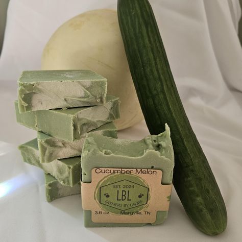 This is a luxurious, artisanal soap bar infused with the clean scent of cucumber and melons! Made with a rich blend of coconut oil, olive oil, cucumber puree, this bar provides a gentle, non-stripping cleanse that nourishes and moisturizes the skin. The crisp aroma of cucumber and the sweetness of melons is perfectly balanced with the subtle richness of the coconut oil and Coconut Milk, creating a unique scent that's both soothing and invigorating. With its vibrant green hue and velvety texture, this soap is a treat for the senses that will leave your skin feeling soft, supple, and beautifully fragrant. Perfect for those seeking a natural, handmade soap that's free from harsh chemicals. Cucumber Soap, Cucumber Scent, Cucumber Melon, Clean Scents, Beauty Soap, Coconut Milk, Handmade Soap, Melon, Bar Soap