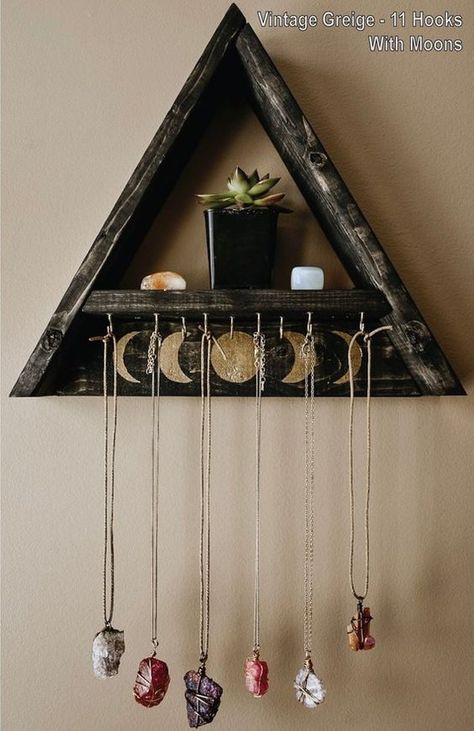 $35 - $45 · This triangle shelf features brass hooks for hanging your favorite jewelry, wall hangings, and keys! 5 and 11 hook options are available. You can also add painted golden moon phases! Choose "With… Triangle Jewelry, Door Hangers Diy, Triangle Shelf, Crystal Shelves, Jewellery Holder, Diy Jewelry Holder, Astuces Diy, Witchy Crafts, Jewelry Hanger