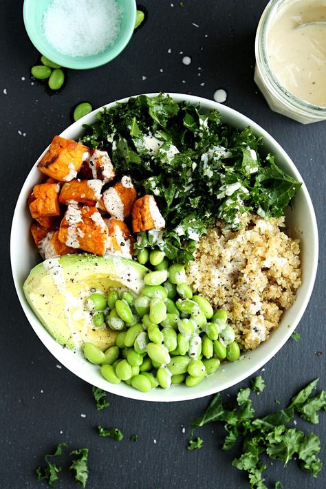 Kale Quinoa Sweet Potato Buddha Bowl Recipe || Made with chopped fresh kale, roasted sweet potatoes, quinoa, avocado, and edamame, and topped with a creamy tahini dressing. #mondaysundaykitchen #buddhabowlrecipes #buddhabowl #besthealthybowls #healthysaladrecipes #sweetpotatobuddhabowl #quinoabuddhabowl #kale Sweet Potato Buddha Bowl, Potato Buddha Bowl, Buddha Bowl Recipe, Kale Quinoa, Quinoa Sweet Potato, Buddha Bowls Recipe, Kale Recipes, Healthy Bowls, Tahini Dressing