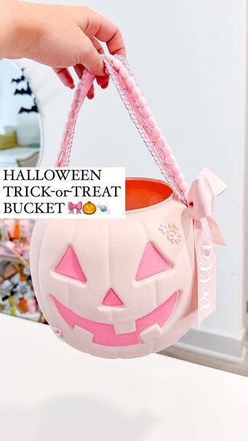 Shelby Parks on Instagram: "Wait until you see how cute he is !!  Halloween buckets can either be SO ugly or so expensive!   So I decided to give the cheap plastic Jack-o-Lantern a ✨glow up✨ by swapping out the handles and using some random things I had around the house   Of course I made mine pink but you could easily recreate this with a different color scheme (I mean how cool would black be???)  *Comment ZHUZH to get all of the tools and supplies I used sent to your inbox 💌  #halloween #halloweendiy #diyhalloween #pinkhalloween #diy #transformation #spookyseason #halloweendiys #howto" Halloween Pumpkin Bucket Ideas, Pumpkin Trick Or Treat Bucket, Pumpkin Bucket Diy, Diy Halloween Bucket, Diy Halloween Buckets For Kids, Diy Trick Or Treat Buckets, Painted Halloween Buckets, Halloween Buckets Ideas, Diy Halloween Buckets