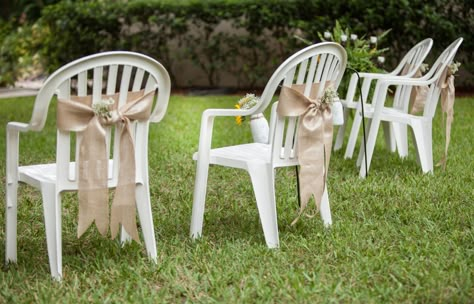 dressed white plastic chairs with burlap detail.                                                                                                                                                      More White Plastic Chairs, Plastic Chairs, Wedding Chair Decorations, בר מצווה, Plastic Chair, Wedding Chairs, Chair Decorations, Wedding Ceremony Decorations, Diy Wedding Decorations