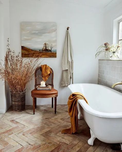 a neutral French bathroom with a grey tile wall, a herringbone floor, a clawfoot tub, a leather chair and dried branches in a basket Waffle Towels, White Paint Colors, Old Cottage, Bathroom Inspo, Clawfoot Tub, Bed Linen Sets, Star Hotel, Australia Living, Lounge Room