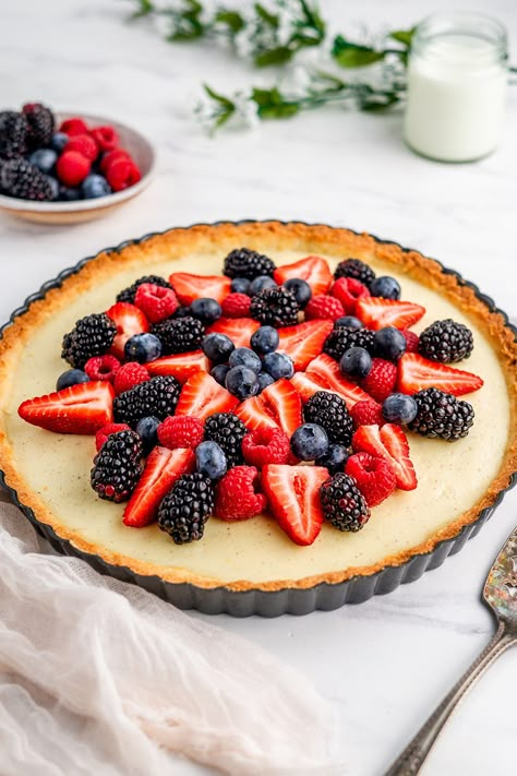 NEW RECIPE! This Vanilla Berry Tart is made with a dense cookie like crust that perfectly holds the layer of fresh, creamy vanilla bean custard and mounds of fresh berries placed on top. This recipe can be made seasonal as the crust and vanilla custard pair perfectly with all different toppings. This recipe was prepared by @frommetovuu for Rodelle's baking challenge #springbakingfling2022 for the prompt Sweet yet Tart. Berry Tart Decoration, Custard Fruit Tart Recipe, Vanilla Custard Tart Recipe, Berry Fruit Tart, Mixed Berry Tart Recipe, Mixed Berry Tart, Vanilla Tart Recipes, Berry Custard Tart, Vanilla Custard Tart