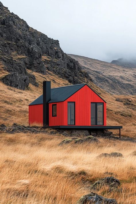 Red cabin nestled against rocky hillside under a gray sky. Little cabins with less space can equal more joy, laughter, and maybe even a whole new perspective on what “downsizing” truly means. Tiny House On Hillside, Mini Home Design, Easdale Island, Mini Cabin Ideas, Concrete Cabin, Tiny Home Floorplan, Tiny Houses Ideas, Red Cabin, Tiny Container House