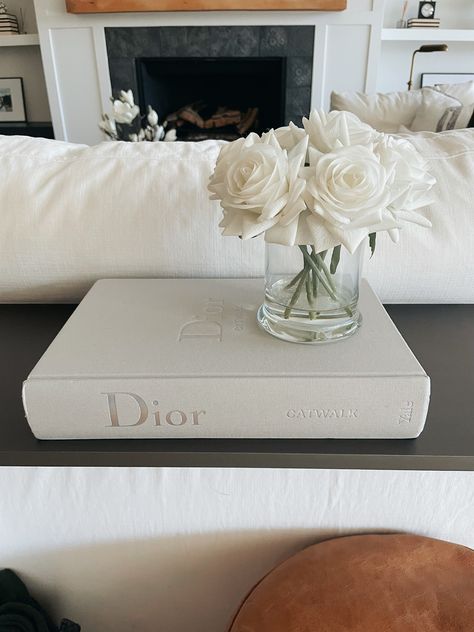 Discover the beauty of delicate neutrals with the Dior Catwalk Book. This stunning book is the perfect addition to your coffee table and will inspire your home decor. #homedecor #DiorCatwalk #neutrals #coffeetablebook #inspiration Catwalk Book Decor, Dior Coffee Table Book, Dior Book Decor, Dior Interior Design, Dior Home Decor, Dior Catwalk Book, Catwalk Books, Dior Catwalk, Kitchen Nook Table