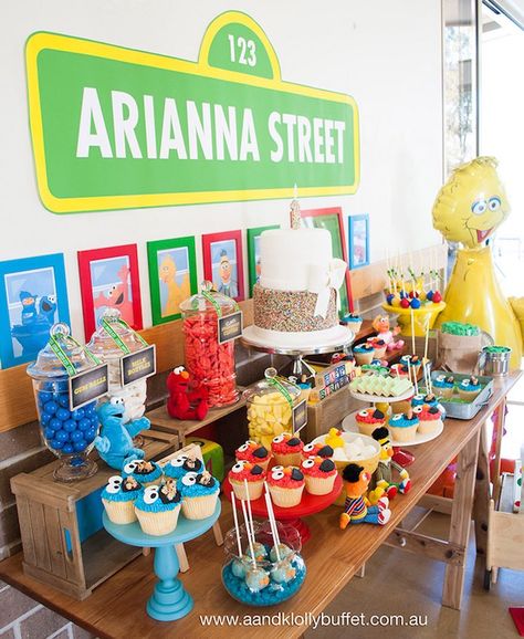 Side-view of the dessert table from a Vintage Sesame Street Birthday Party Sesame Street Treat Table Ideas, Elmo Dessert Table, Vintage Sesame Street Party, Sesame Street Desserts, Seaseme Street 1st Birthday Party, Sesame Street Dessert Table, Elmo 1st Birthday Party, Seaseme Street Birthday Party, Sesame Street Birthday Party Ideas Boy