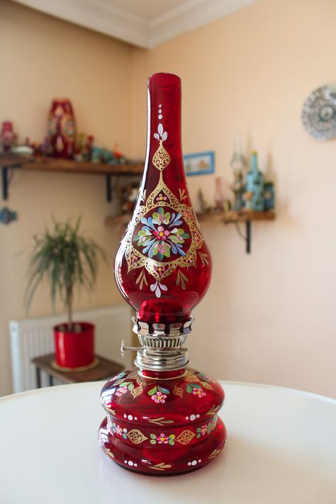 MEDIUM-SIZED OIL LAMP Decorative oil lamp with beautiful handmade art. An elegant addition to your room decoration. COLOR Background color: Red HANDMADE Background toning and foreground painting are all handmade.  Minor differences in painting and toning could be observed between the items of the same category.   DIMENSIONS Width (radius): 11.5 cm Height: 33.5 cm NOTES Suitable for dry cleaning. The lamp could be lit using proper oils. Overheating is not recommended. PERA ART HOUSE We create bea Antique Decorating Ideas, Vintage Items Antiques, Oil Lamp Decor, Handmade Background, Antique Oil Lamp, Antique Things, Antique Oil Lamps, Old Lamps, Beautiful Wallpaper For Phone