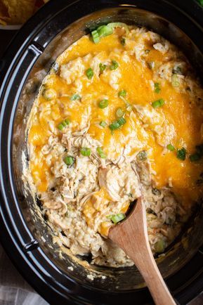 Slow Cooker Green Chile Chicken and Rice Casserole #crockpot #slowcooker #casserole #chicken #chickenrecipes #crockpotrecipes #cheesy #spicy Green Chili Chicken Casserole Crockpot, Hatch Green Chili Recipes Slow Cooker, Slow Cooker Green Chili Chicken And Rice, Green Chili Crockpot Recipes, Green Chili Chicken Crockpot Slow Cooker, Chicken Green Chili Crockpot, Crockpot Green Chili Chicken, Green Chili Chicken Crockpot, Green Chile Chicken And Rice